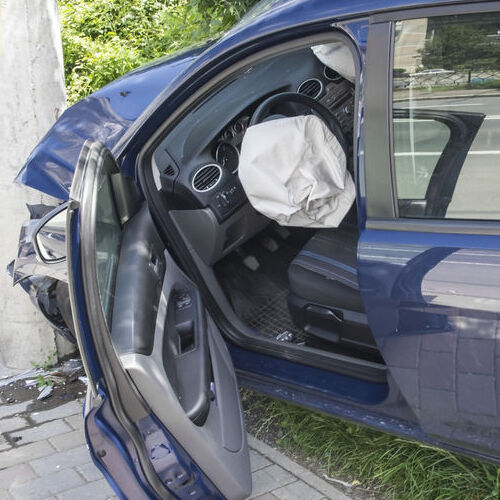 A Wrecked Car With Deployed Air Bag.