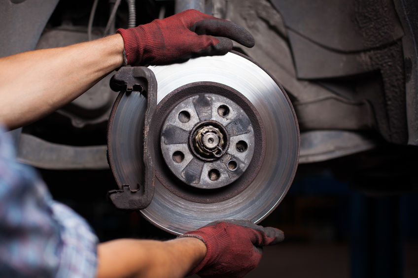 mechanic working on car brakes