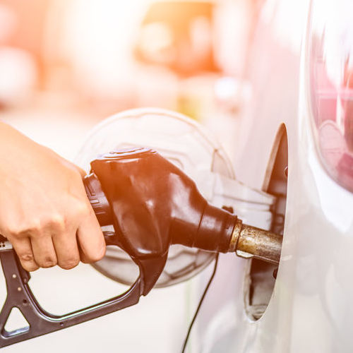 A Woman Pumps Gas in a Car.