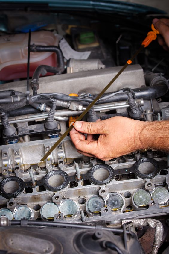 checking dipstick during oil change